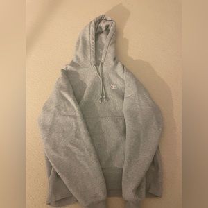 A grey Champion hoodie, size medium.
